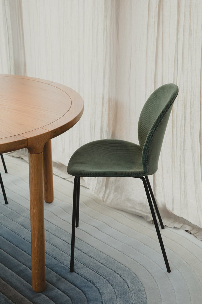 Green Bonnet chair with black metal frame, ribcord fabric with texture.. 