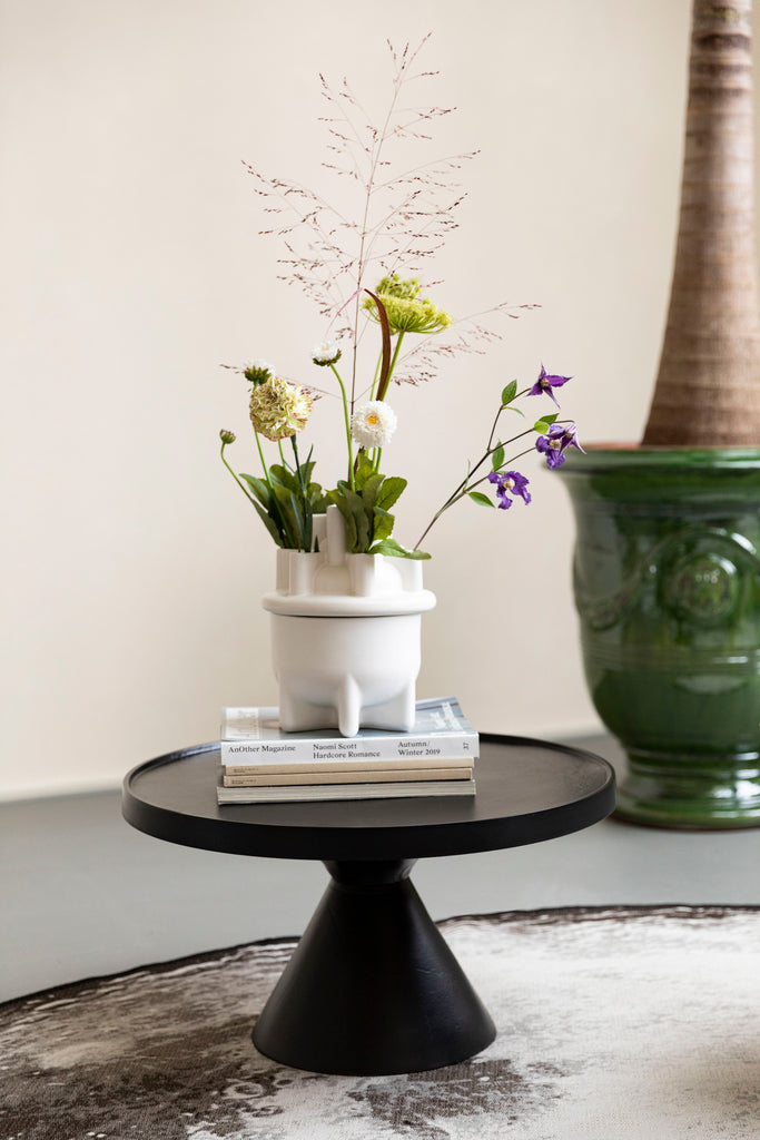 Jason Coffee Table in black colour with books and vase.