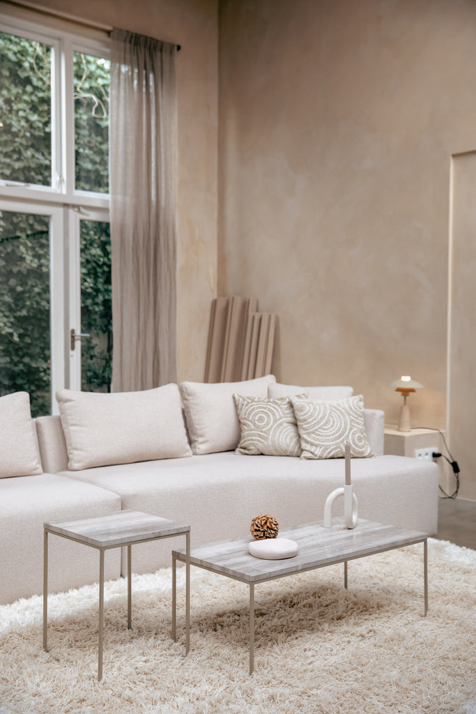 Marble Coffee Tables STRAY with iron base beside bright couch.