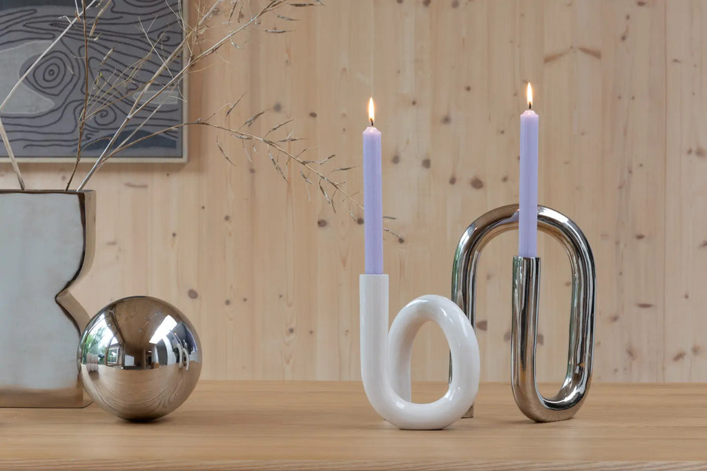 Tubo effortlessly merges modern aesthetics with timeless charm. Shaped like a curved tube.&nbsp;  Indulge in the finer things in life and enhance your living space with Tubo. Whether paired together or standing alone, these aluminium candle holders promise to be a timeless investment in your home decor. The gleaming surface exudes opulence, making it a statement piece in any room.