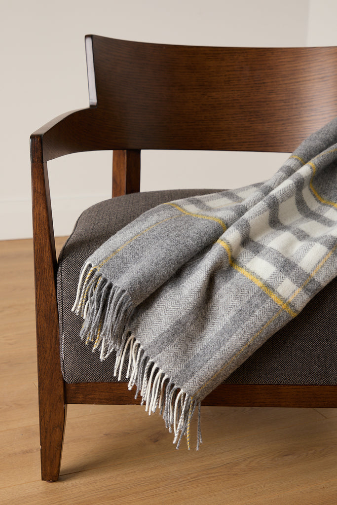 Designed and expertly woven at our mill, the Liath Lambswool Comfort Throw is a contemporary take on a traditional style.

Made using 100% lambswool in a soft grey, white and yellow palette.

Our comfort throws are a slightly smaller version of our bestselling standard throws – ideal for cosying up on the sofa or draping over the back of your favourite armchair.