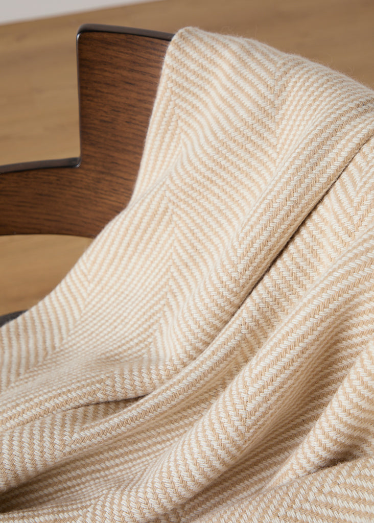 Crafted with expertise at our renowned Foxford Mill, this elegant Merino throw is the perfect addition to any room with its baby camel and white herringbone pattern. Made from the highest quality merino wool, it provides unmatched softness and warmth for cosy evenings by the fire or lazy Sunday mornings with a cup of tea.