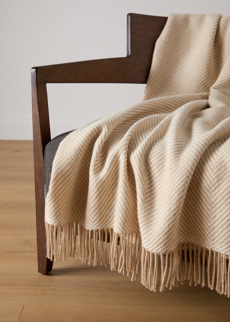 Crafted with expertise at our renowned Foxford Mill, this elegant Merino throw is the perfect addition to any room with its baby camel and white herringbone pattern. Made from the highest quality merino wool, it provides unmatched softness and warmth for cosy evenings by the fire or lazy Sunday mornings with a cup of tea.