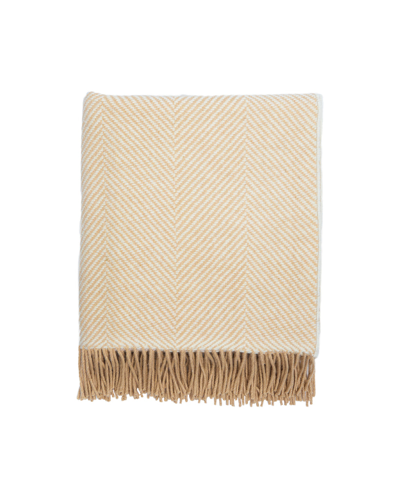 Crafted with expertise at our renowned Foxford Mill, this elegant Merino throw is the perfect addition to any room with its baby camel and white herringbone pattern. Made from the highest quality merino wool, it provides unmatched softness and warmth for cosy evenings by the fire or lazy Sunday mornings with a cup of tea.