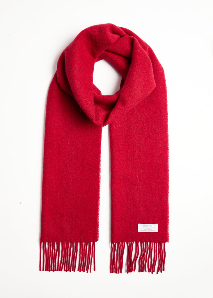 Expertly crafted using traditional weaving techniques, the Foxford Dearg scarf is a well-known design made from 100% lambswool. It is finished with a traditional roll fringe and features a rich tomato reds. This classic scarf in neutral grey-greens is the perfect addition to any wardrobe.

Each one is made in County Mayo and individually quality checked before leaving the mill.