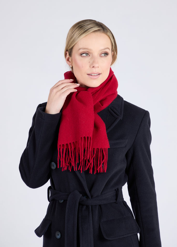 Expertly crafted using traditional weaving techniques, the Foxford Dearg scarf is a well-known design made from 100% lambswool. It is finished with a traditional roll fringe and features a rich tomato reds. This classic scarf in neutral grey-greens is the perfect addition to any wardrobe.

Each one is made in County Mayo and individually quality checked before leaving the mill.