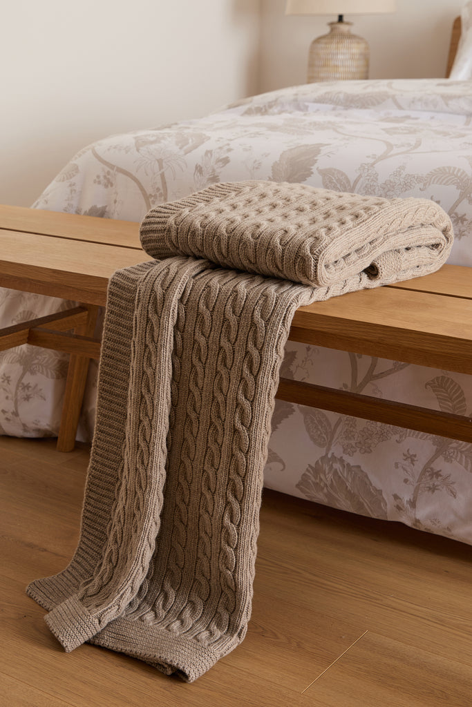 Foxford Cable Knit Beige Merino Bed Blanket (130x170 cm), designed in Ireland, featuring a classic cable knit pattern in soft merino wool.