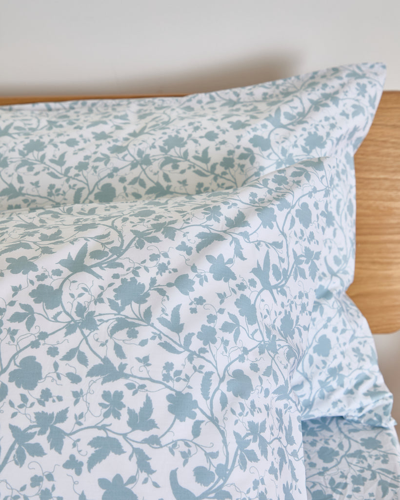 Add elegance to your bedding with the Foxford Claire Pillowcase Set in white. You feature a slate blue floral print on a lighter base, offering a subtle contrast for added visual interest.

Designed by renowned Irish designer Helen McAlinden, these pillowcases are crafted from 100% premium cotton. They have a luxurious 300-thread count for a soft, smooth finish. Expertly woven in Portugal, this set embodies the perfect balance of comfort and style.

The Foxford Claire Pillowcase Set pairs beautifully with o