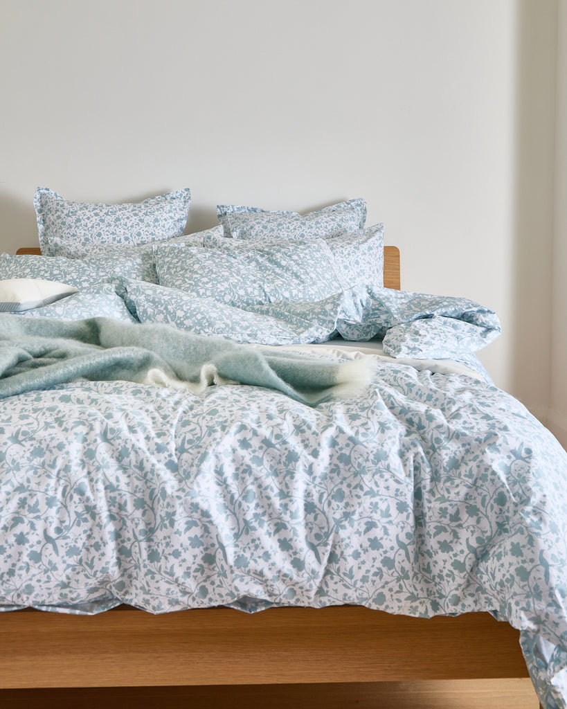 Add elegance to your bedding with the Foxford Claire Pillowcase Set in white. You feature a slate blue floral print on a lighter base, offering a subtle contrast for added visual interest.

Designed by renowned Irish designer Helen McAlinden, these pillowcases are crafted from 100% premium cotton. They have a luxurious 300-thread count for a soft, smooth finish. Expertly woven in Portugal, this set embodies the perfect balance of comfort and style.

The Foxford Claire Pillowcase Set pairs beautifully with o