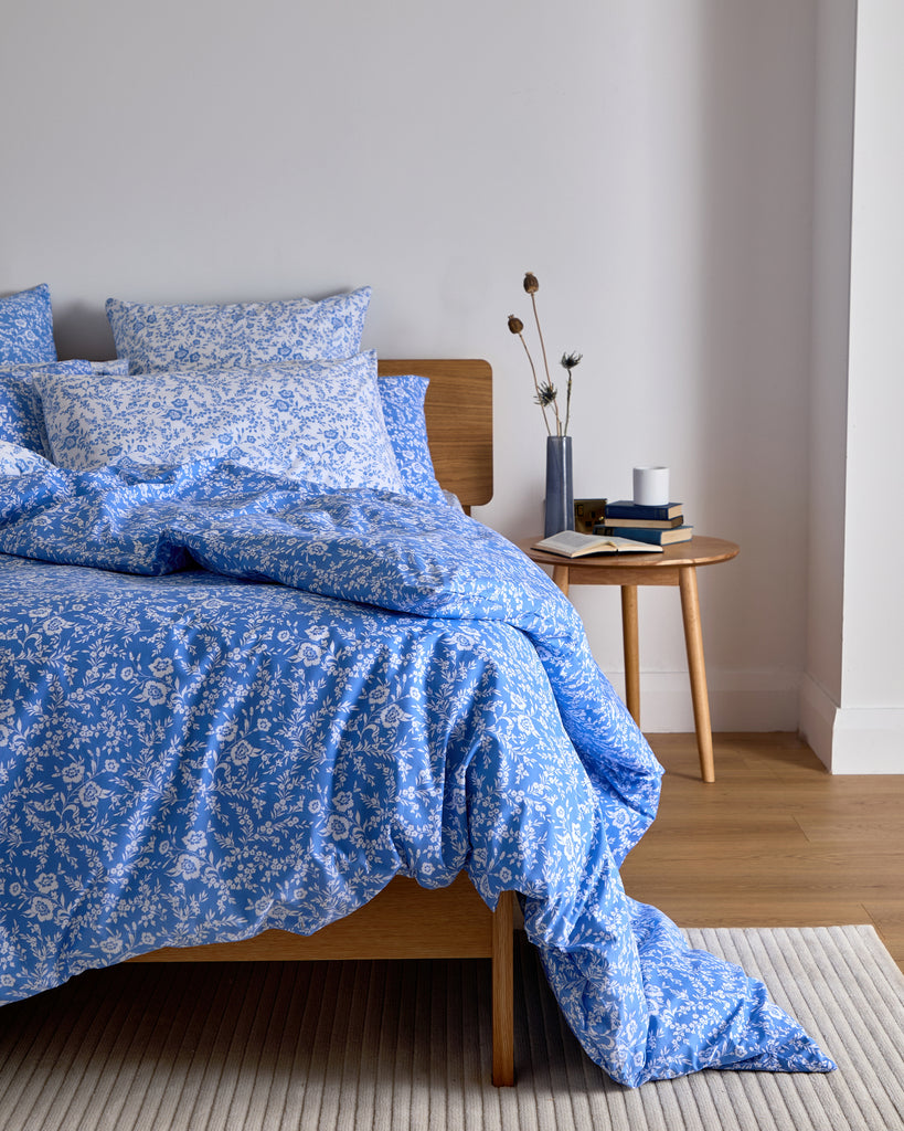 Introducing the Foxford Clara Duvet Set in cobalt blue, designed by Helen McAlinden. This striking design features delicate white wildflowers, bringing a sense of elegance and nature into your bedroom.