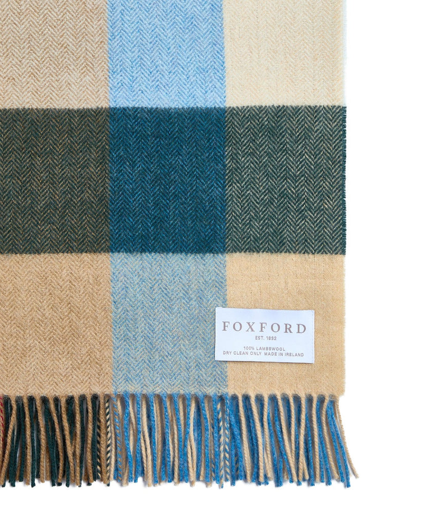 Add some rustic charm to your home with this beautifully soft comfort throw. Expertly crafted in our County Mayo mill, the traditional palette features shades of blue, bone, moss and red. Made from 100% lambswool and finished with a traditional roll fringe, it’s the ideal way to add a touch of warmth to your home.

Our comfort throws are a slightly smaller version of our bestselling standard throws – ideal for cosying up on the sofa or draping over the back of your favourite armchair.