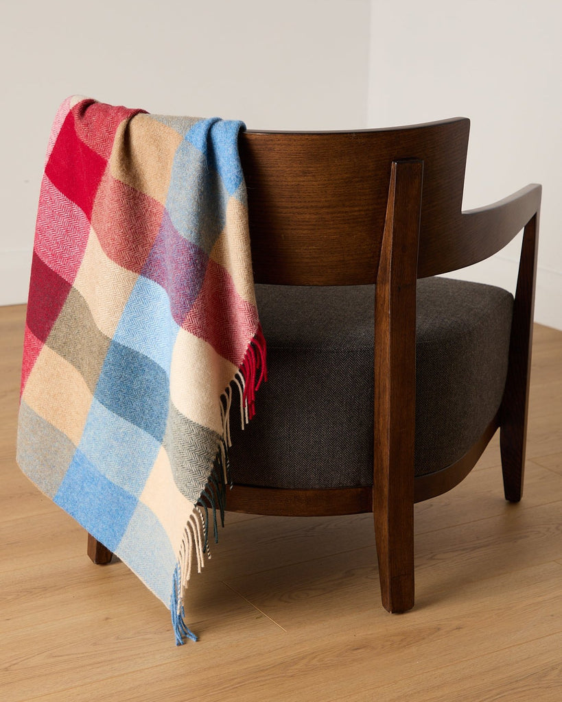 Add some rustic charm to your home with this beautifully soft comfort throw. Expertly crafted in our County Mayo mill, the traditional palette features shades of blue, bone, moss and red. Made from 100% lambswool and finished with a traditional roll fringe, it’s the ideal way to add a touch of warmth to your home.

Our comfort throws are a slightly smaller version of our bestselling standard throws – ideal for cosying up on the sofa or draping over the back of your favourite armchair.