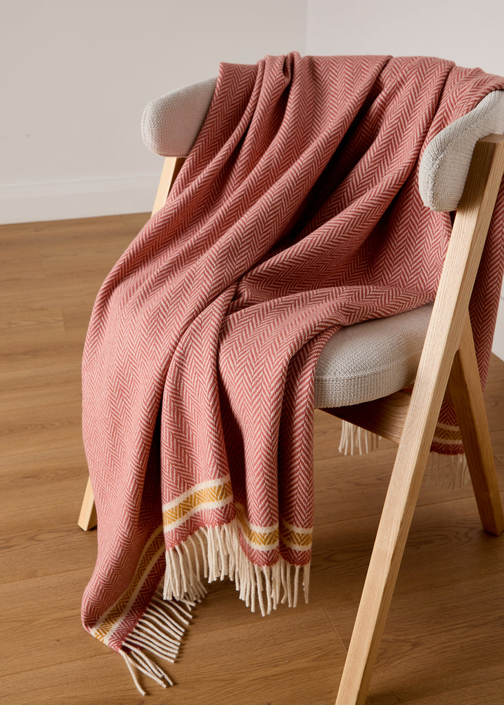 inishcrone throw terracotta herringbone cashmere throws draped over a chair