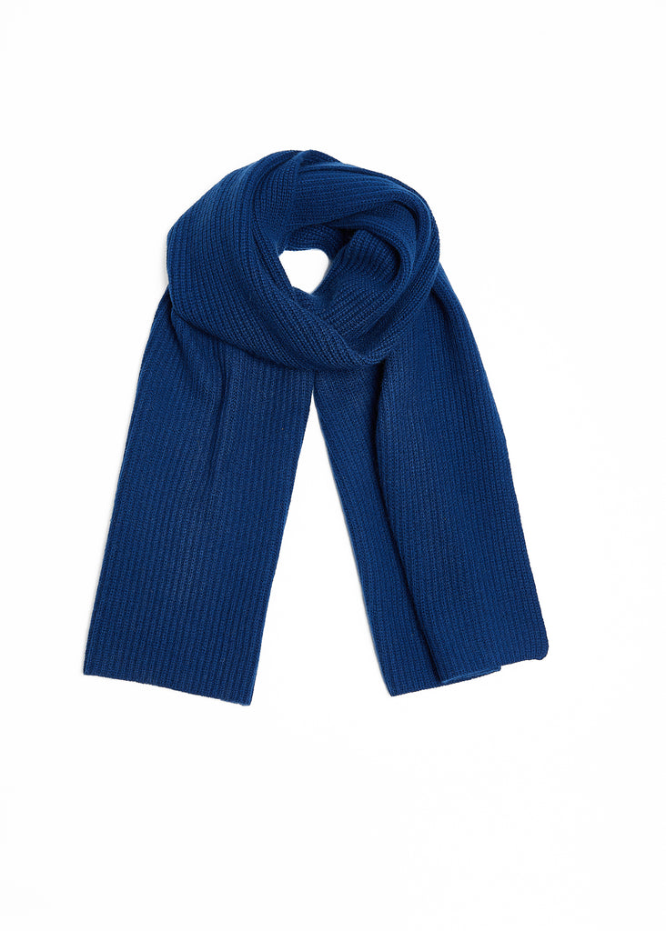 Crafted from the finest cashmere fibers, this unisex navy scarf features a timeless ribbed design, making it the perfect accessory for any outfit. Soft to the touch and effortlessly elegant, this knitted scarf is a must-have addition to any luxury wardrobe.