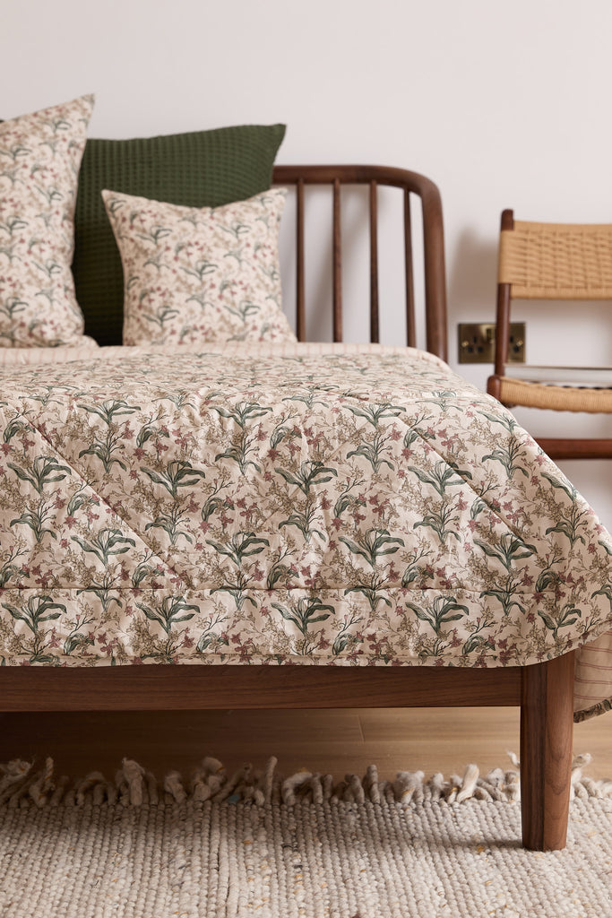 Foxford Romantic Blossom Quilted Blanket, made in Portugal with a 300 thread count of 100% cotton, is expertly crafted to provide luxurious comfort and long-lasting durability.