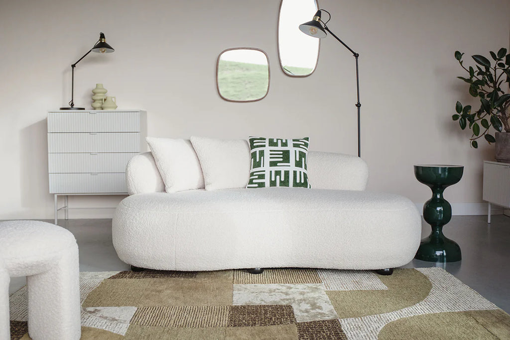 Experience pure luxury with the Foxford Cloud Bouclé Sofa. Its sleek and modern design instantly elevates any living space, while the curved shape and white color add a touch of sophistication. Unwind and relax in ultimate comfort with this exclusive piece.