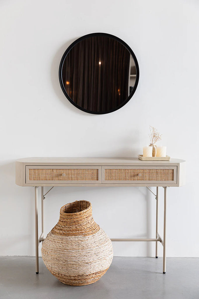 The Foxford Emily Two Door Console desk is designed to complement the Japandi style and seamlessly integrate into any interior. Constructed from wood, the desk features two woven rattan drawers for added texture. Its light colors and rounded shape contribute to a tranquil and peaceful appearance.