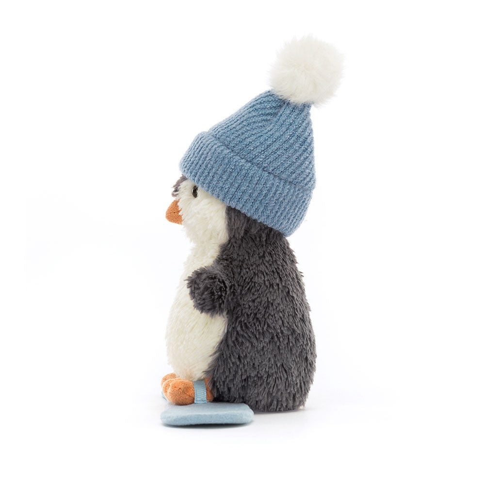 Peanut Penguin Snowboarding is ready to wobble down the slopes! Lovably soft in blue-grey fur, with a cream tummy, little flippers and orange beak and feet, our intrepid chick rides a blue suedette board. Wearing a cosy blue knitted hat with fluffy snowball pompom, this penguin's a gorgeous good-luck charm.