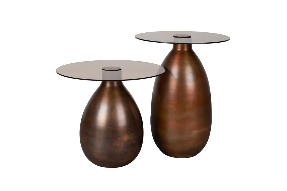 If you're looking for unique items for your home, you're in the right place with the Dutchbone Selene. What immediately stands out about this side table set is its striking base, made of iron. The matt, bronze finish creates a beautiful reflection of light entering the room. This creates a pleasant, warm atmosphere where you immediately feel at home. The tabletop in dark smoked glass completes the look and gives it a fine vintage feel. Perfect for creating an intimate setting in your home where you can esca