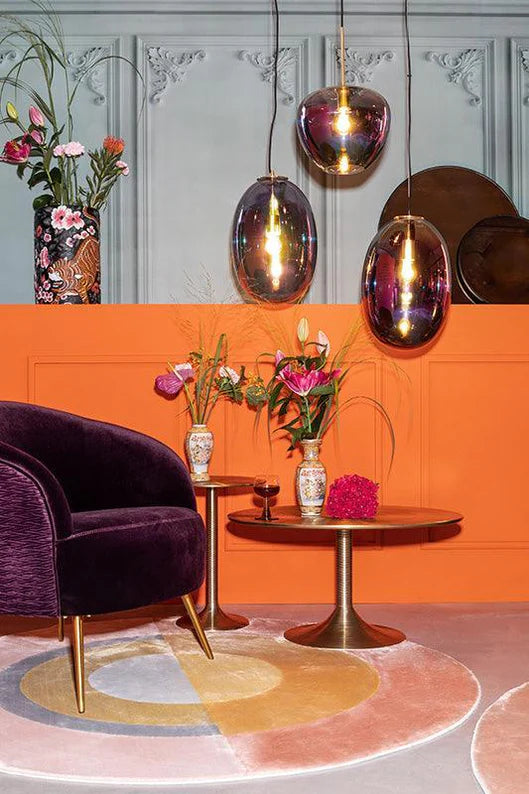 Hypnotising Round Side Table Gold in orange and red room setting